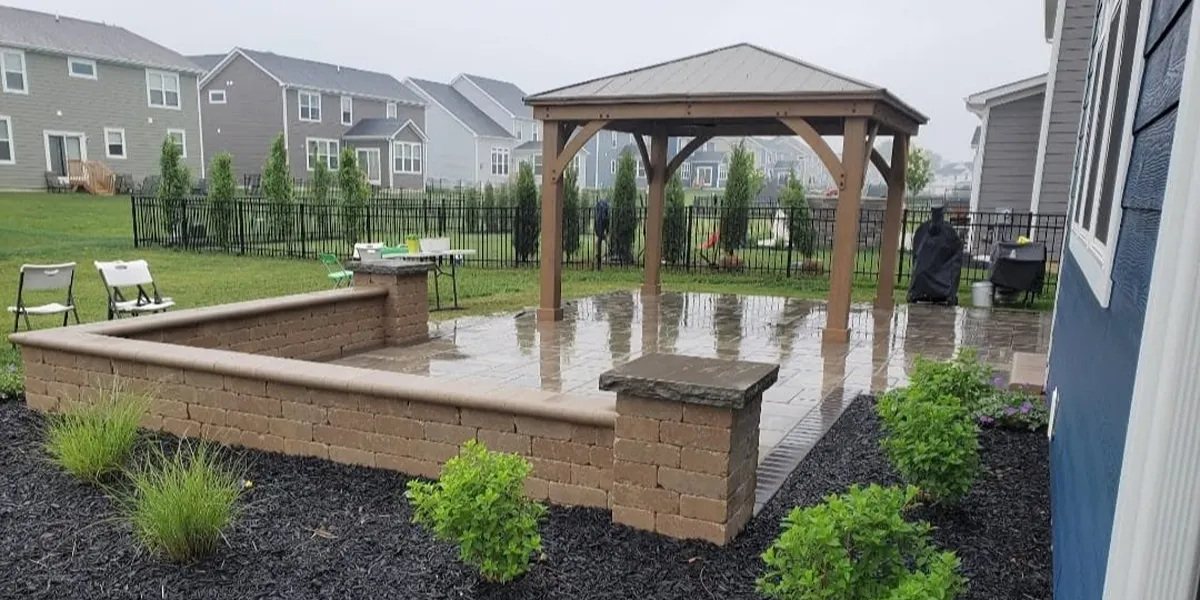 Beautiful Unilock paver patio with a pavilion to replace the basic builder backyard.